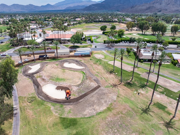 Hole 6 mid-demolition at The Springs Country Club, with construction equipment actively removing turf and reshaping the site for renovation.
